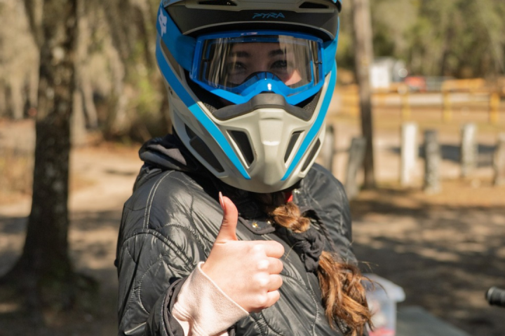 Person in helmet giving thumbs up, BRP Experiences logo above.